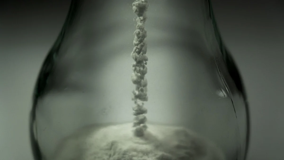 Illustrative photograph of unlabelled white powder falling into a glass vessel for Citicoline